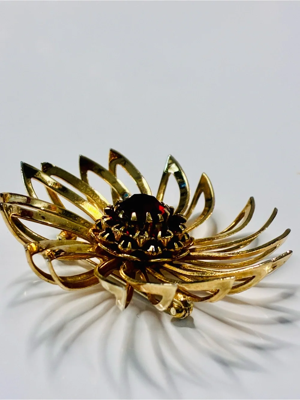 Sarah Coventry Gold-tone Sunburst Brooch with Deep Red Center